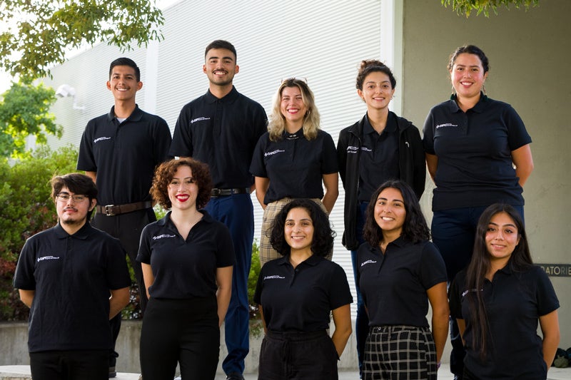 Ten Society of Hispanic Professional Engineers board members stand in black polo shirts