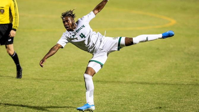 Cal Poly soccer player kicking during a game.